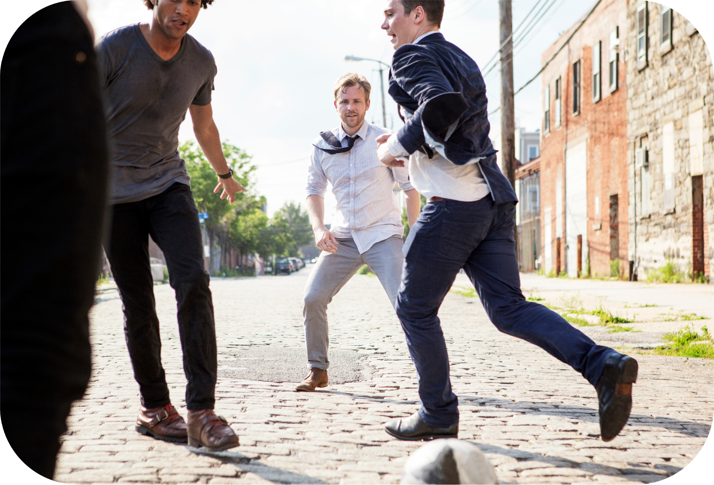 group of men paying pickup soccer in a town square